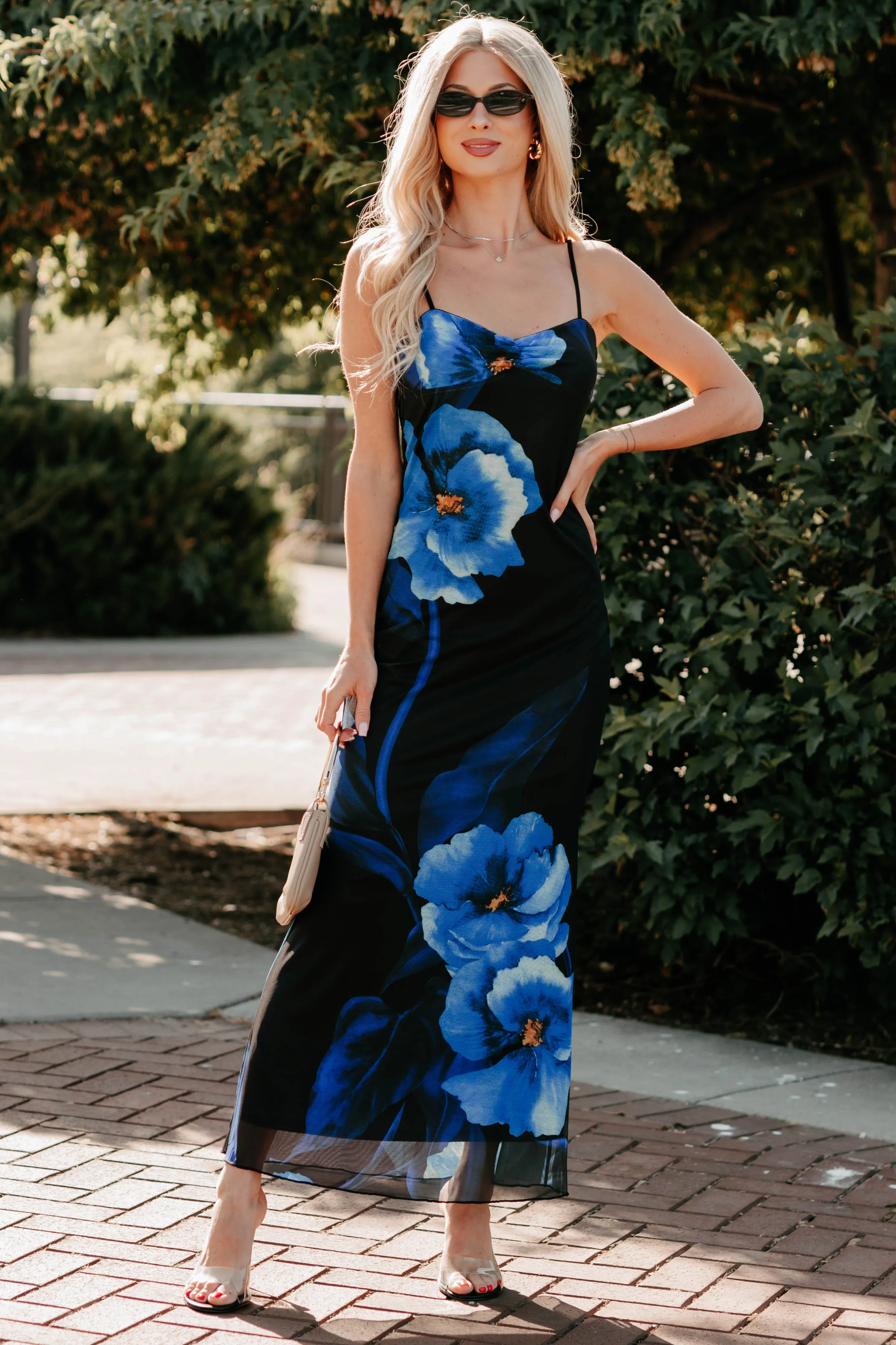 The simple silhouette of this dress makes it easy to style for both day and night wear Chic Uprising Sleeveless Floral Maxi Dress (Black/Blue)